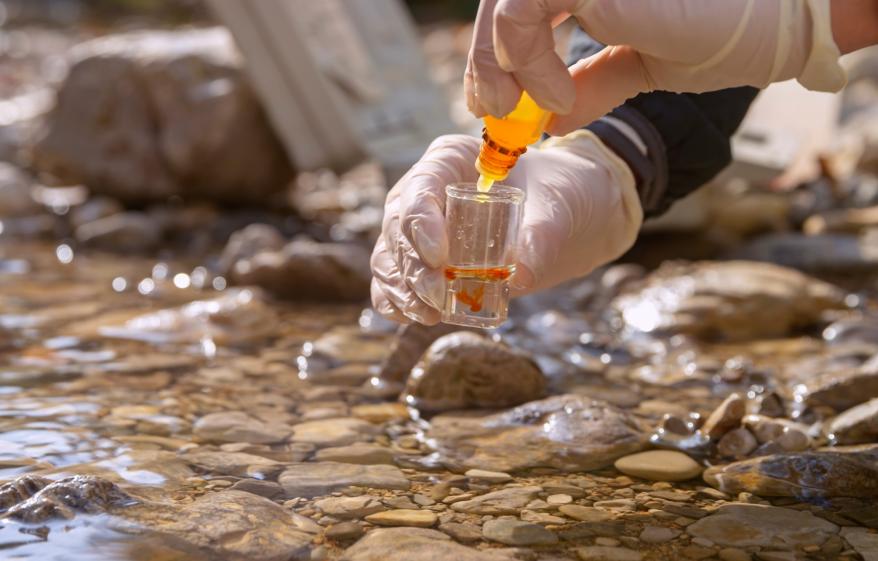 collecting a water sample from a river