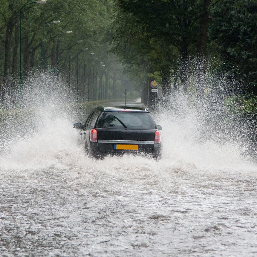 car being driven through a flooded road
