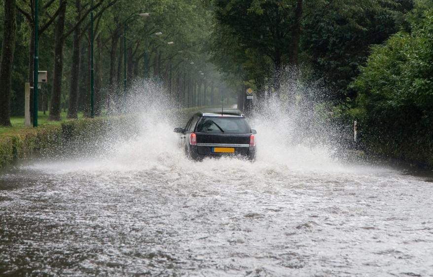 a car driving through a flooded road