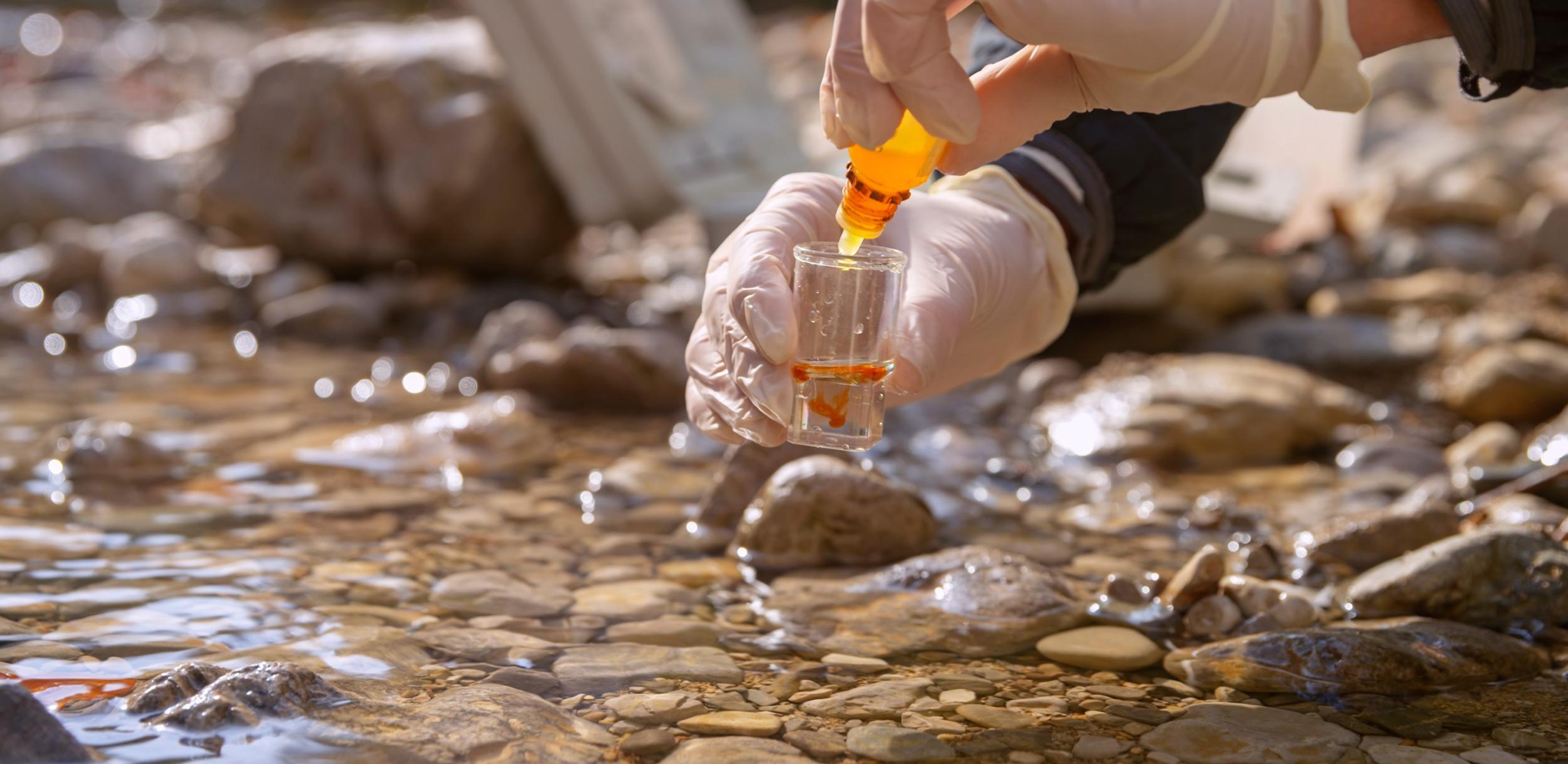 collecting a water sample from a river