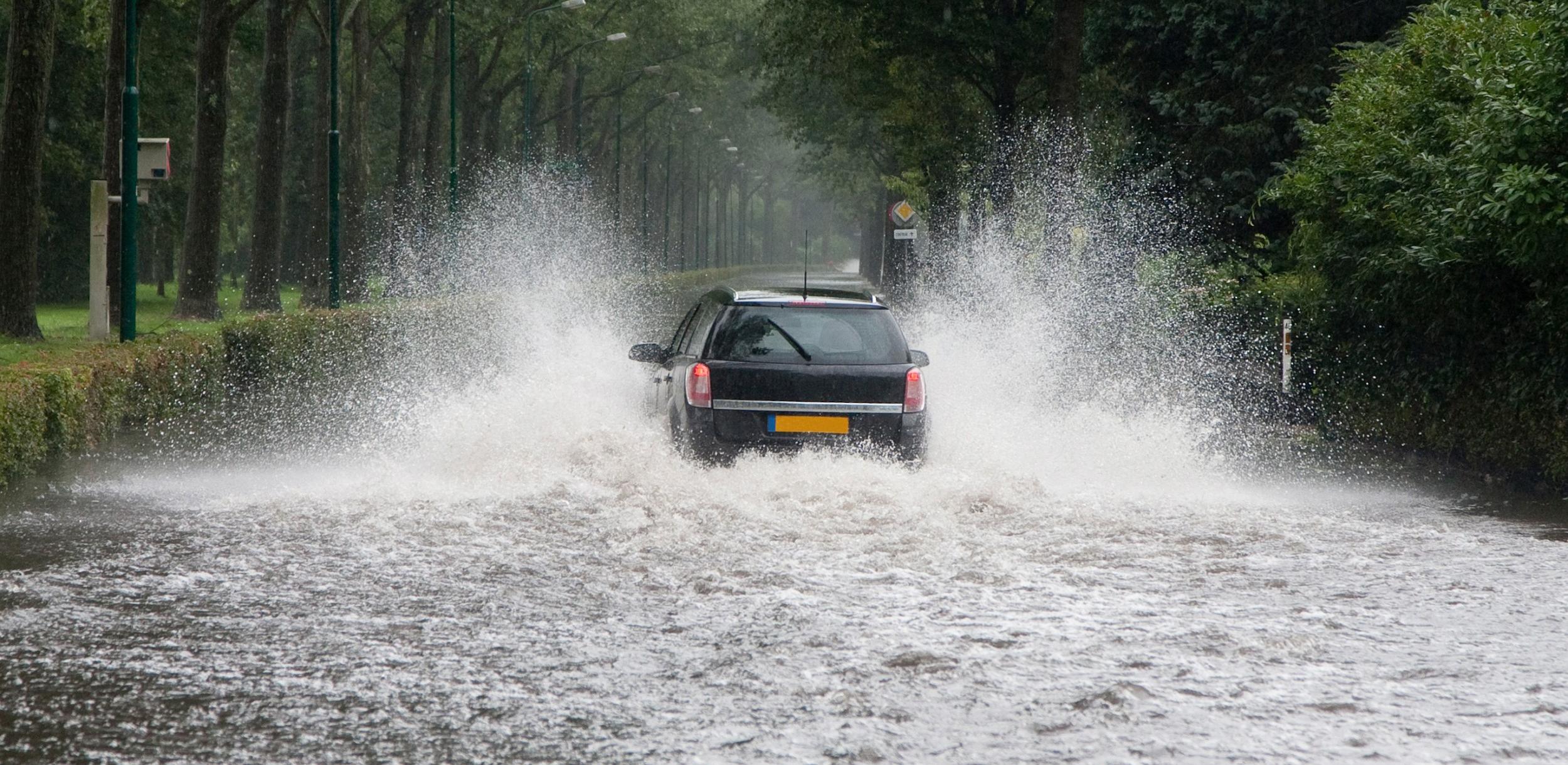 a car driving through a flooded road